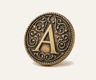 Reference render of the letter A coin in antiqued brass